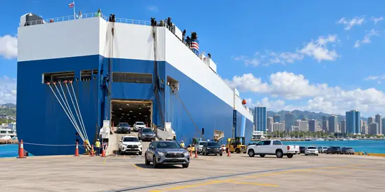 A roll-on, roll-off ship unloading cars in Honolulu