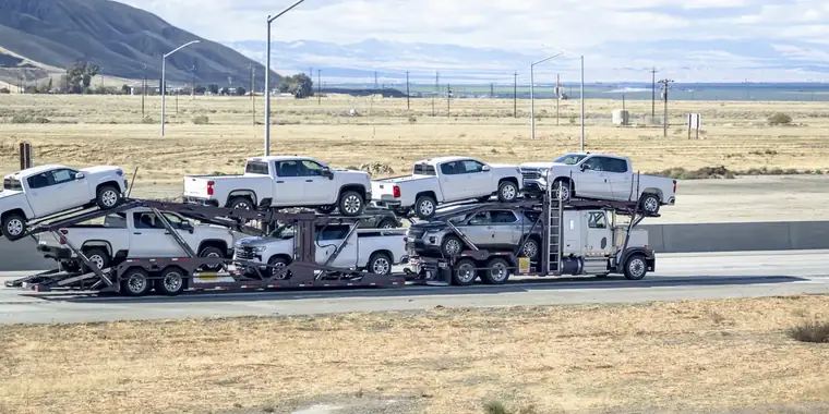 Pickup trucks loaded on a car carrier